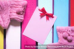 Cute message card and pink baby booties with copy space 4Br334