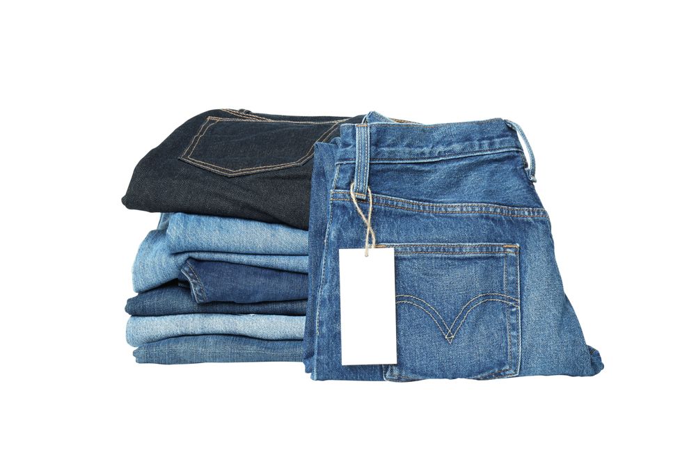 Folded jeans, isolated on light background