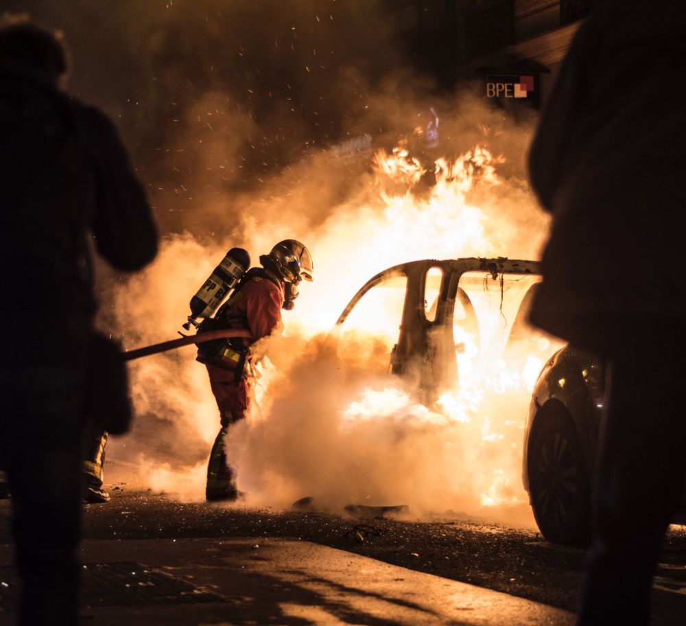 Firefighter extinguish fire in a car
