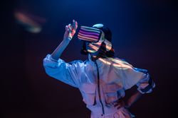 Woman touching air in VR glasses