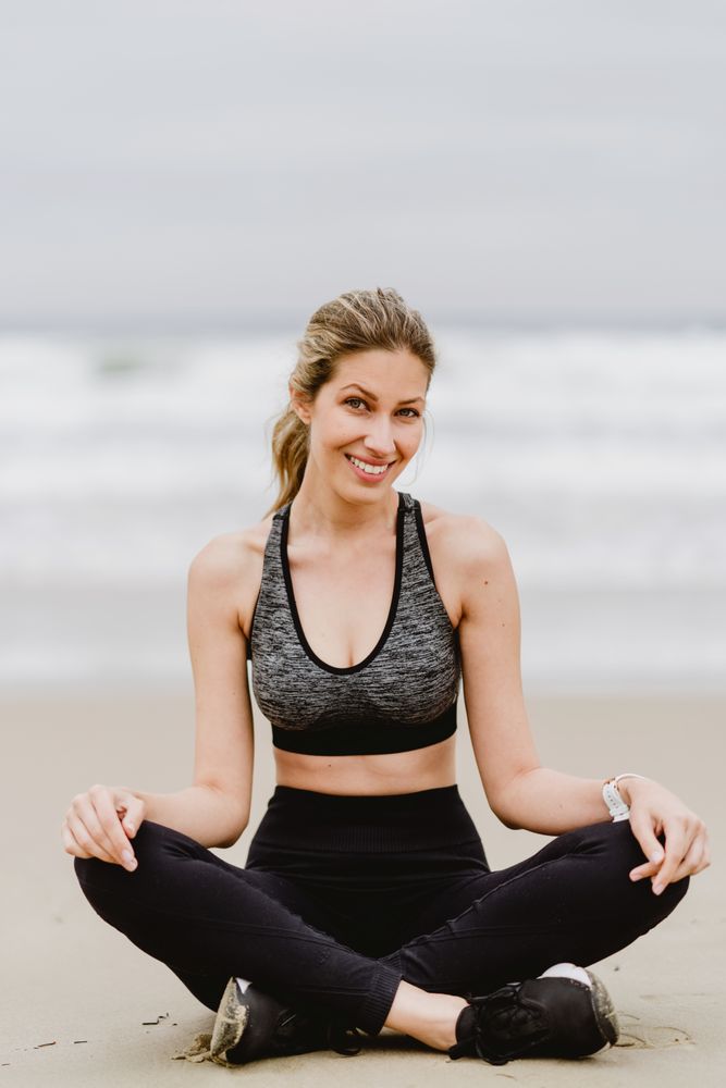 Woman meditating on the beach