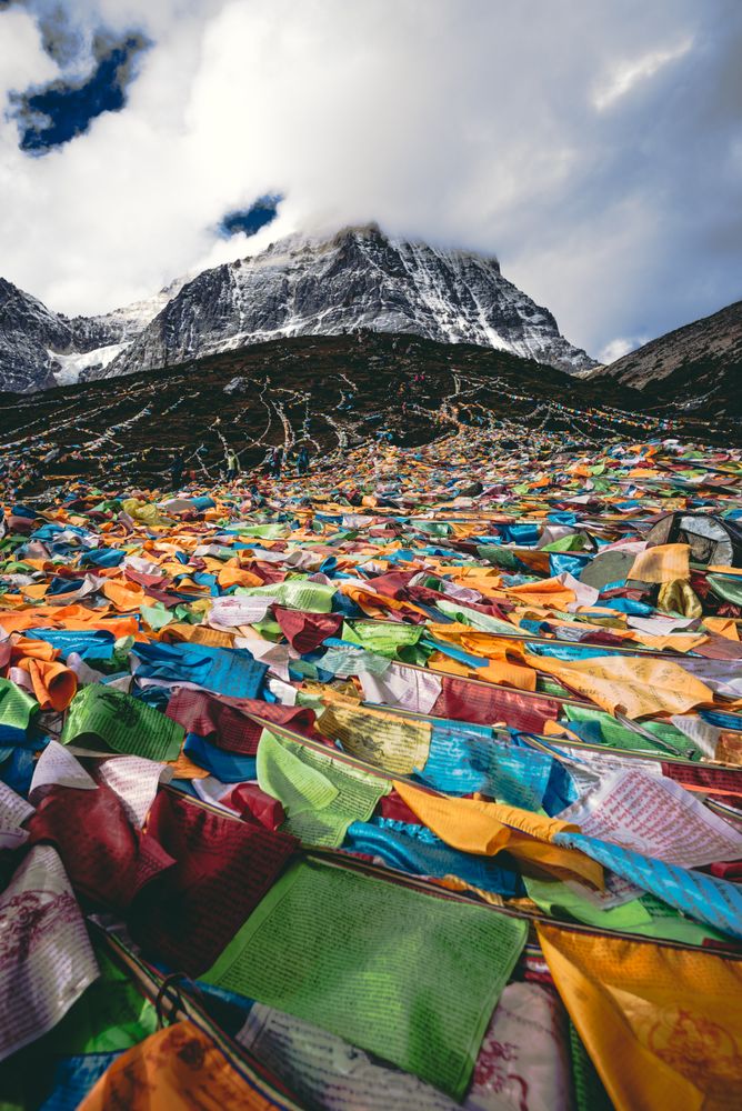 Assorted-color textile near mountainous landform in Daocheng, Tibet