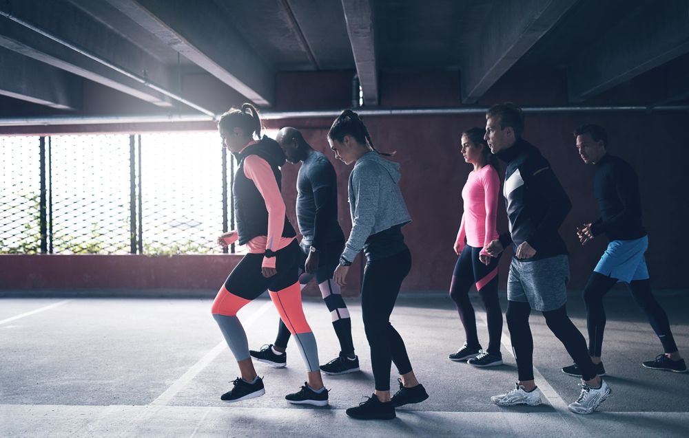 Side view of people preparing to go for a run