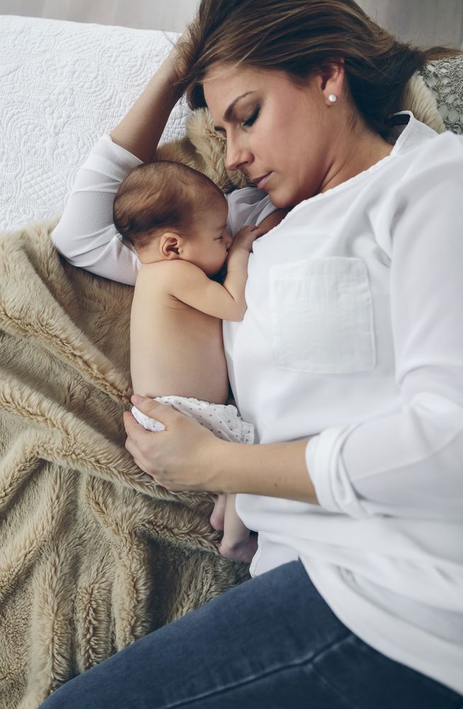 Mother hugging her newborn baby girl
