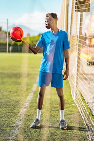 Black teenager on football field