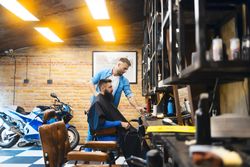 Barber with client talking about styles before cutting