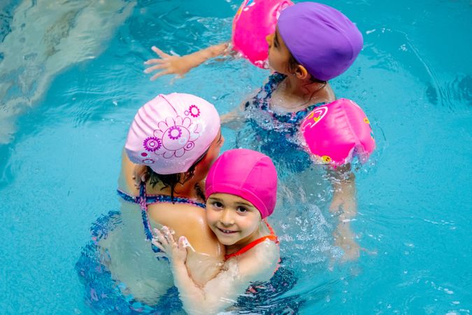 girls with water wings in swimming pool