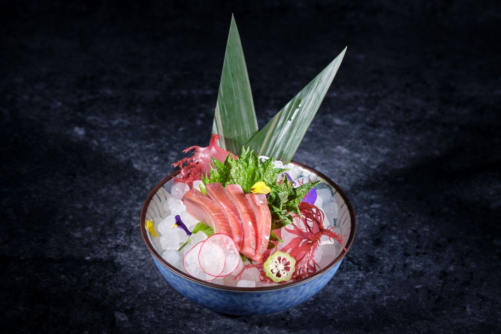 Ceramic plate with raw fish and vegetables