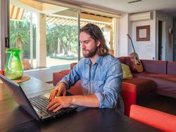 Focused man using computer in apartment