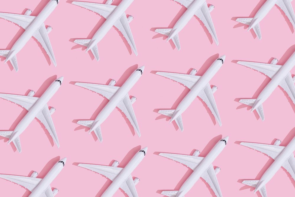 Passenger plane pattern on pastel pink background