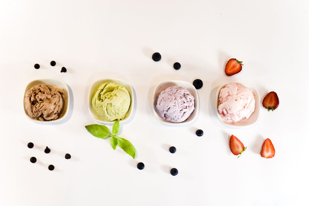 Top view of four small bowls of colorful ice cream