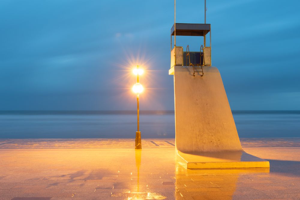 Lonely tower of lifeguard on beach at dusk