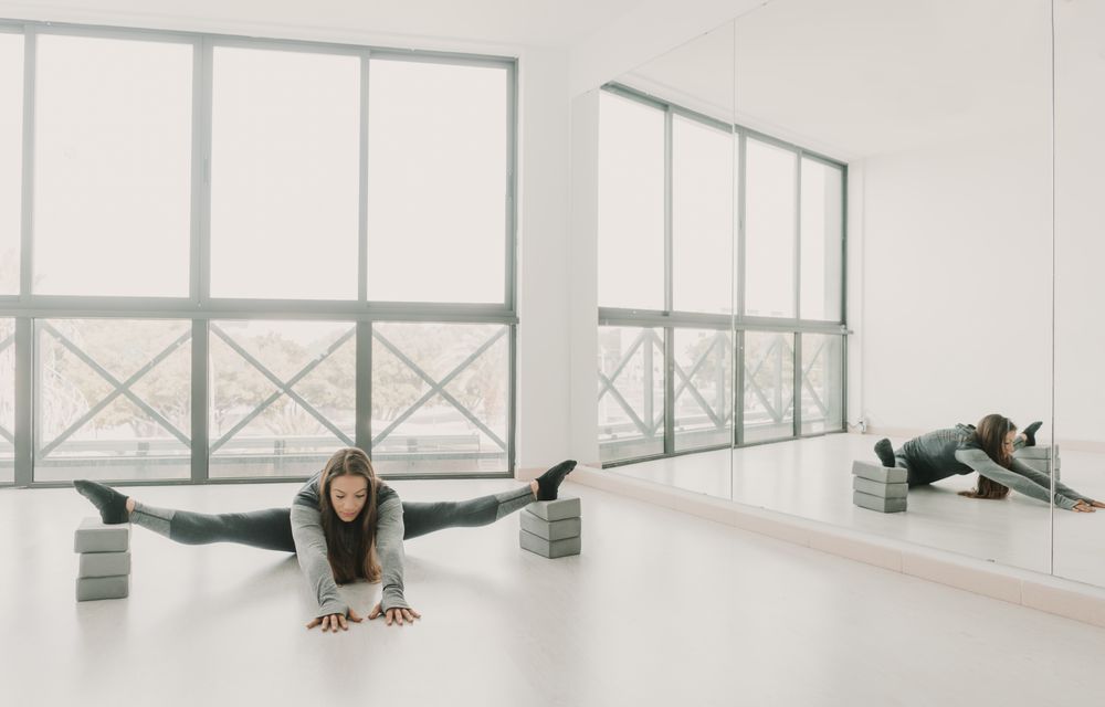 Flexible woman stretching in studio