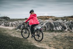 Female cyclist riding on mountain road