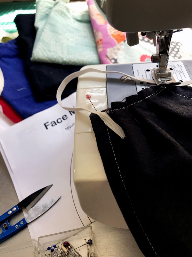 Sewing machine with fabric face mask and craft pattern