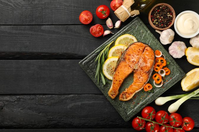 Composition with tasty grilled salmon on wooden background, top view