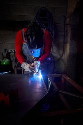 Concentrated craftsman welding metal detail