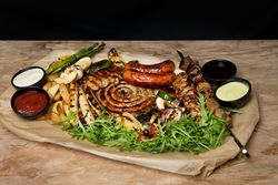 Sauces near fried meat and vegetables