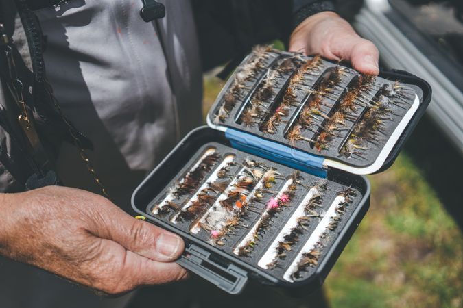 Fisherman demonstrating collection of baiting in box