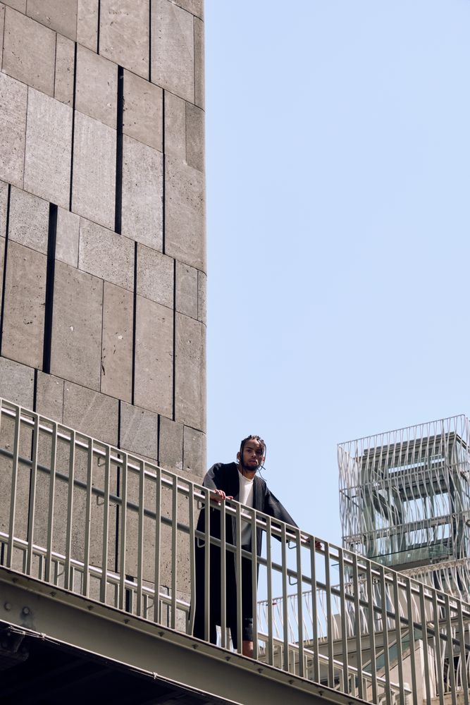 Black male standing on bridge