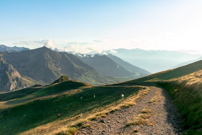Road leading to rocky valley under clouds