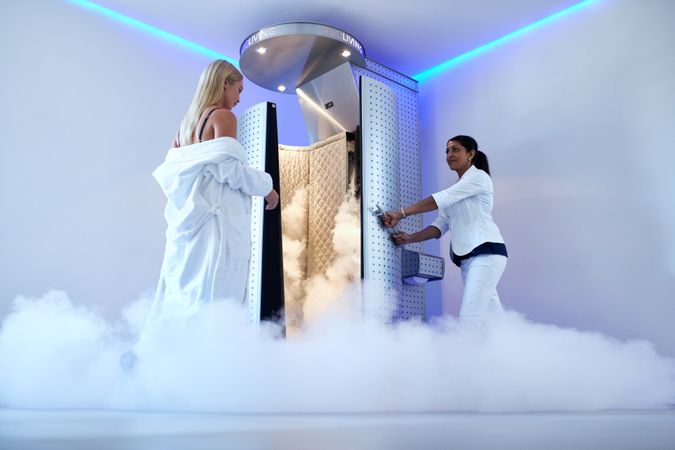 Cryotherapy technician guiding client