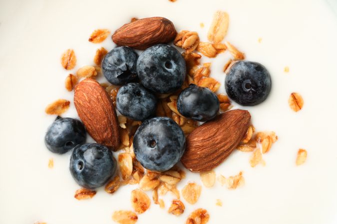 Parfaits dessert with fruits and nuts as background, closeup