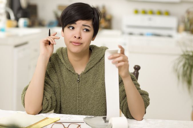 Young Woman Agonizing Over Financial Calculations