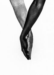 Two multi-ethnic hands holding each other in a loving way