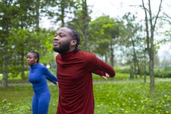 Young man and his friend warming up before their training.