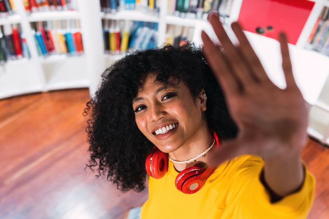 Portrait of cheerful Black woman in headphones