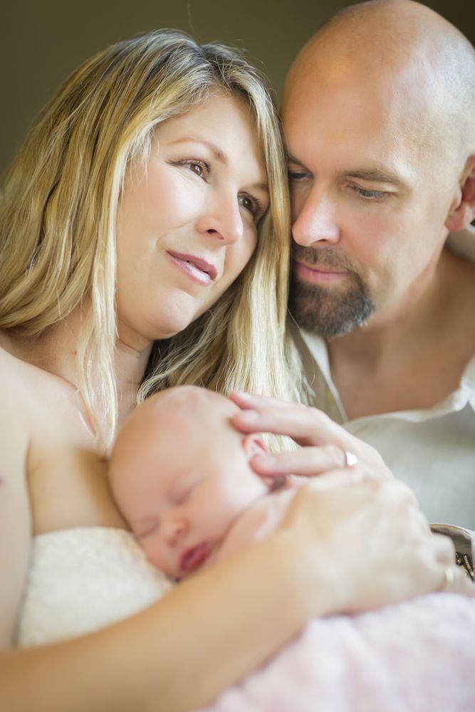 Couple Holding Their Newborn Baby Girl