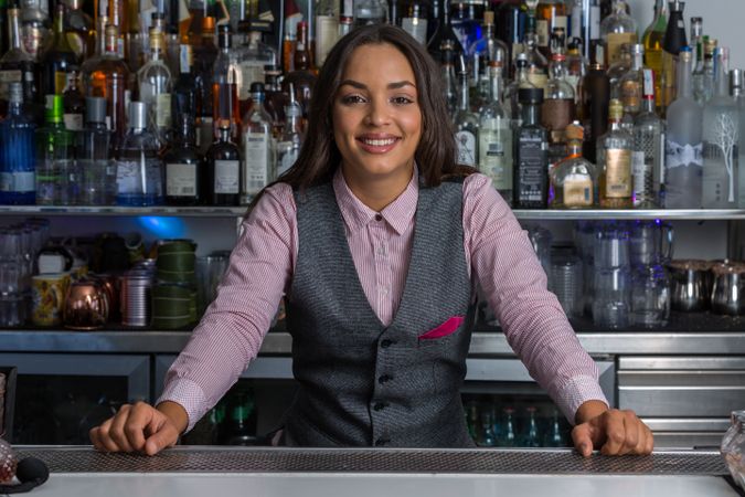 Smiling bartender standing at the bar