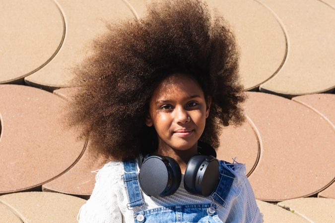 Black girl listening to music with headphones