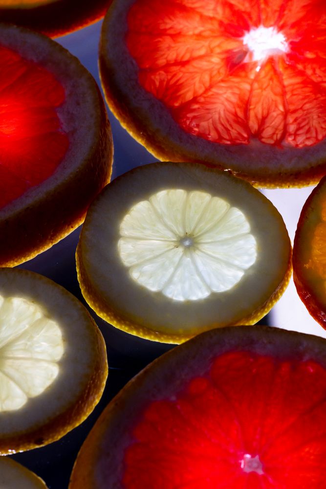Sliced citrus fruits against light