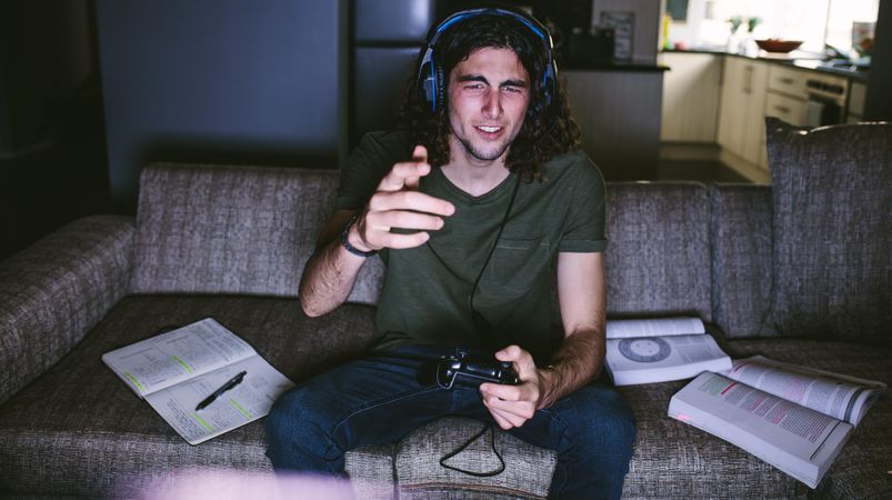 Young man conversing with video game players using his headset