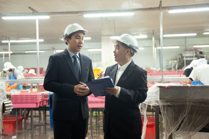 Entrepreneur inspecting at food processing in manufacturing line production.