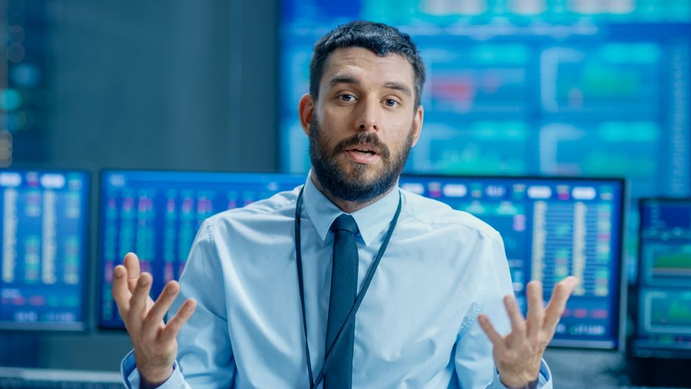 Professional Stock Market Trader Charismatically Talks into the Camera.