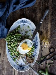 Delicious breakfast meal with steamed peas and egg