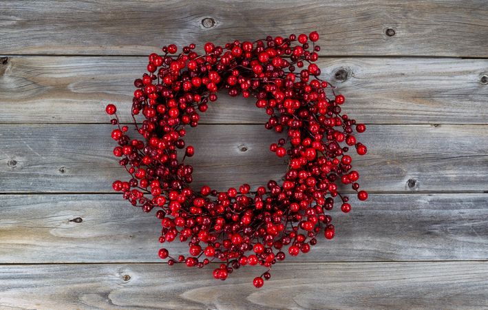 Red berry holiday wreath on old wood