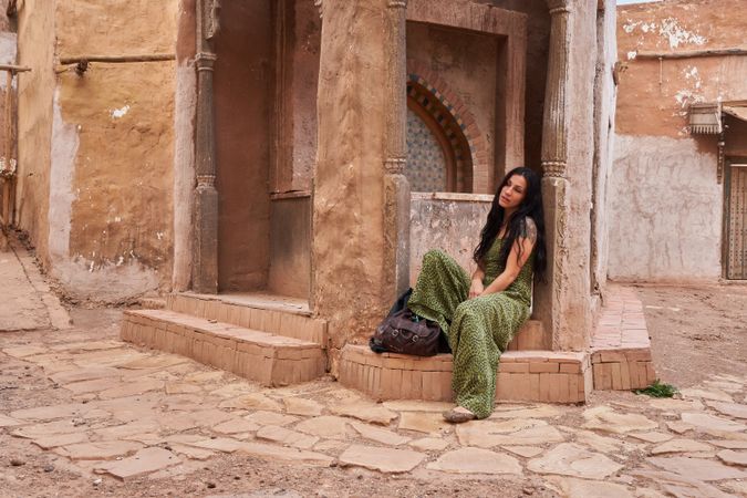 Woman on street between ancient buildings