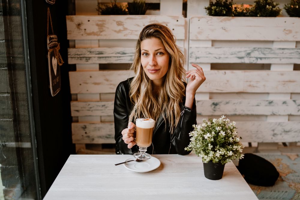 Woman drinking coffee from a glass