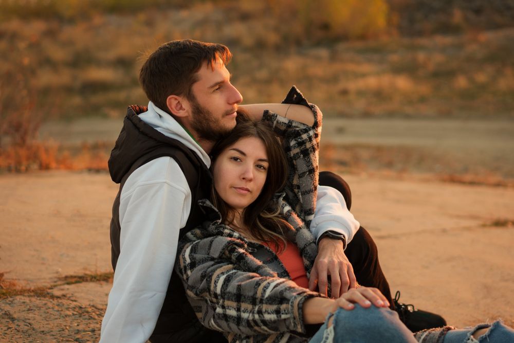 Couple sitting dusk countryside