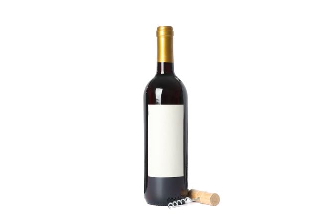 Corkscrew and bottle with red wine isolated on plain background