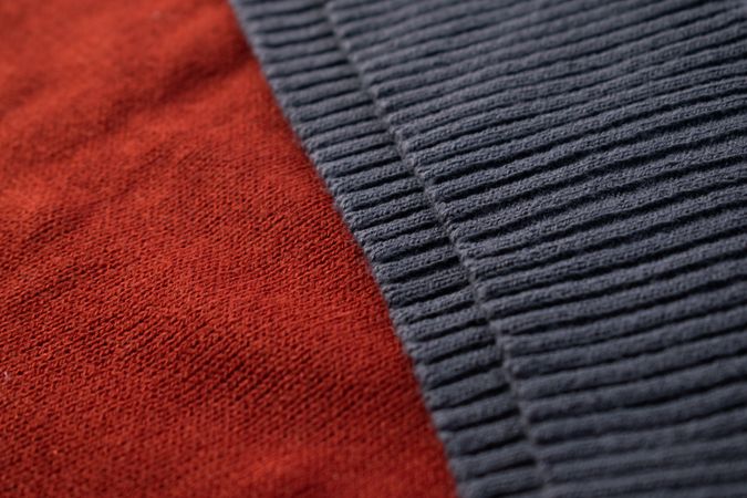 Close up dark grey knitted fabric background texture.