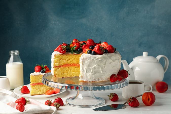 Composition with delicious berry cream cake on  wooden table. Tasty dessert