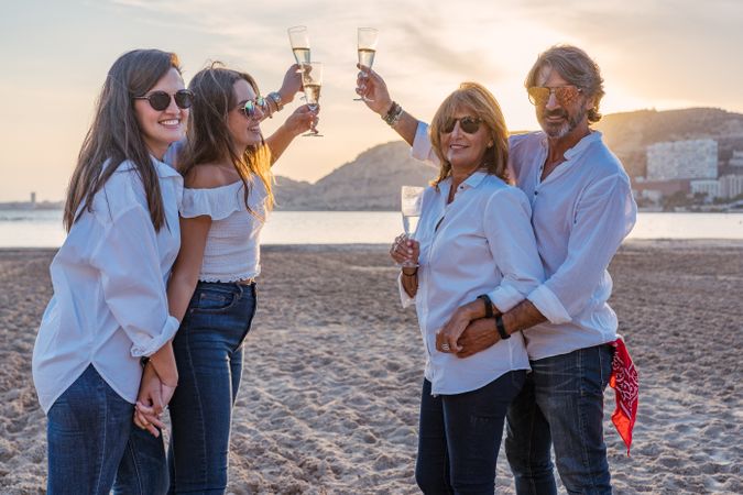 Happy family drinking wine on beach