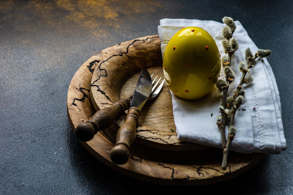 Easter table setting with decorative golden eggs on rustic plates