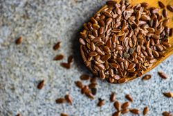 Vintage wooden spoon with flax seeds
