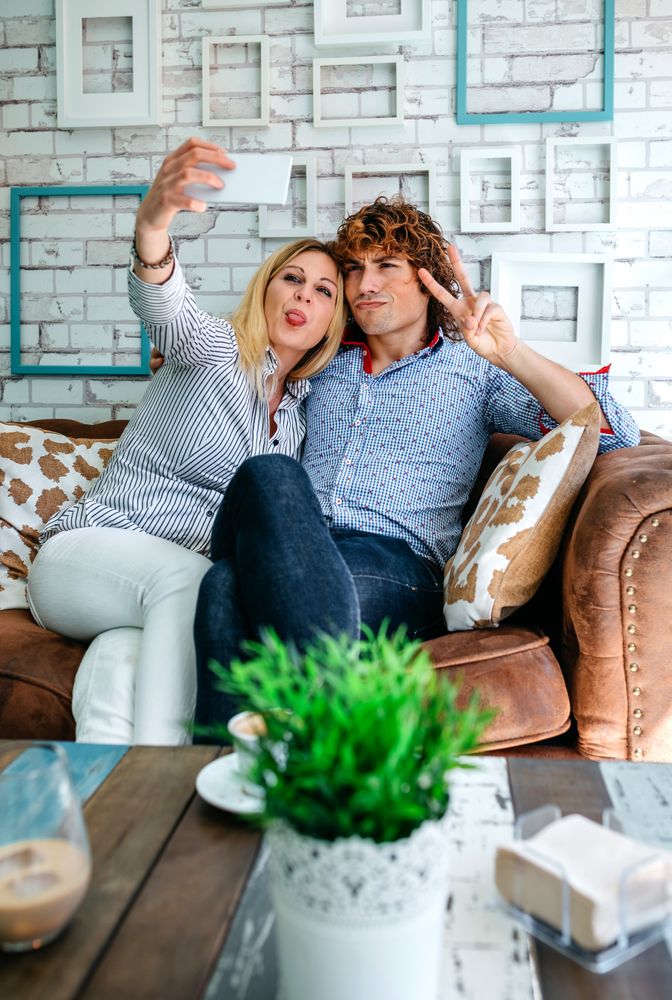 Couple taking selfie on a sofa